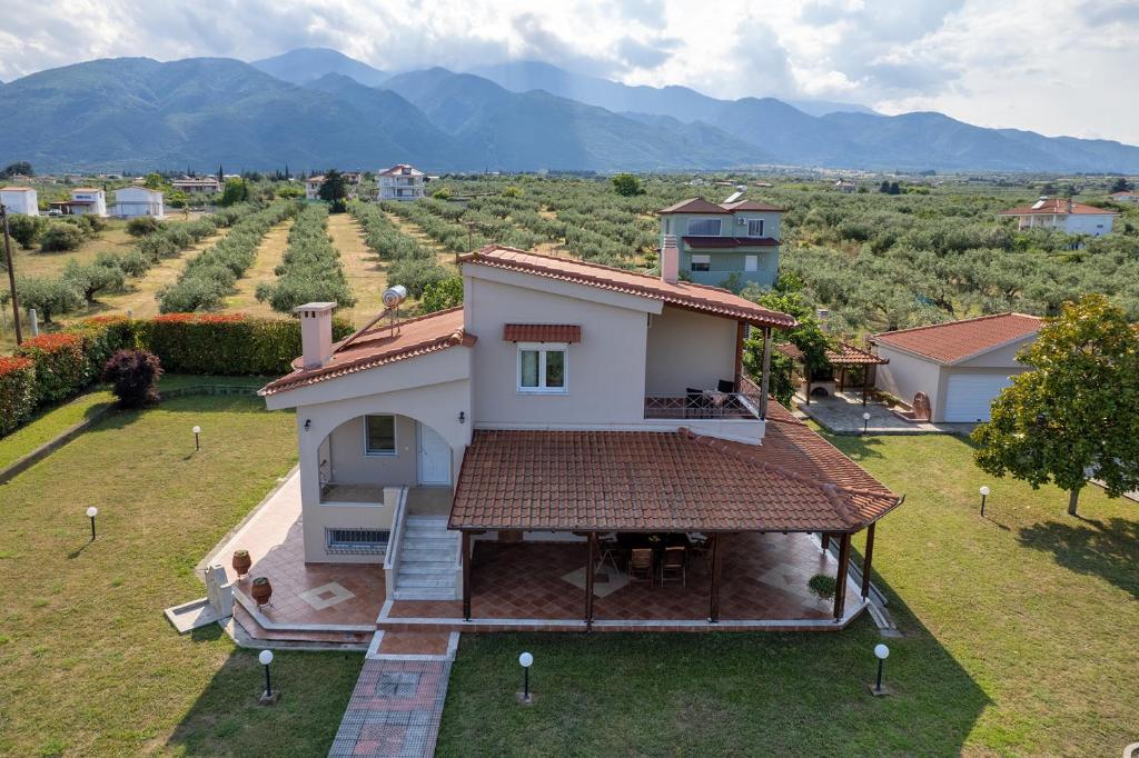 an aerial view of a house with mountains in the background at Zeusplace Sunny Villa in Leptokarya