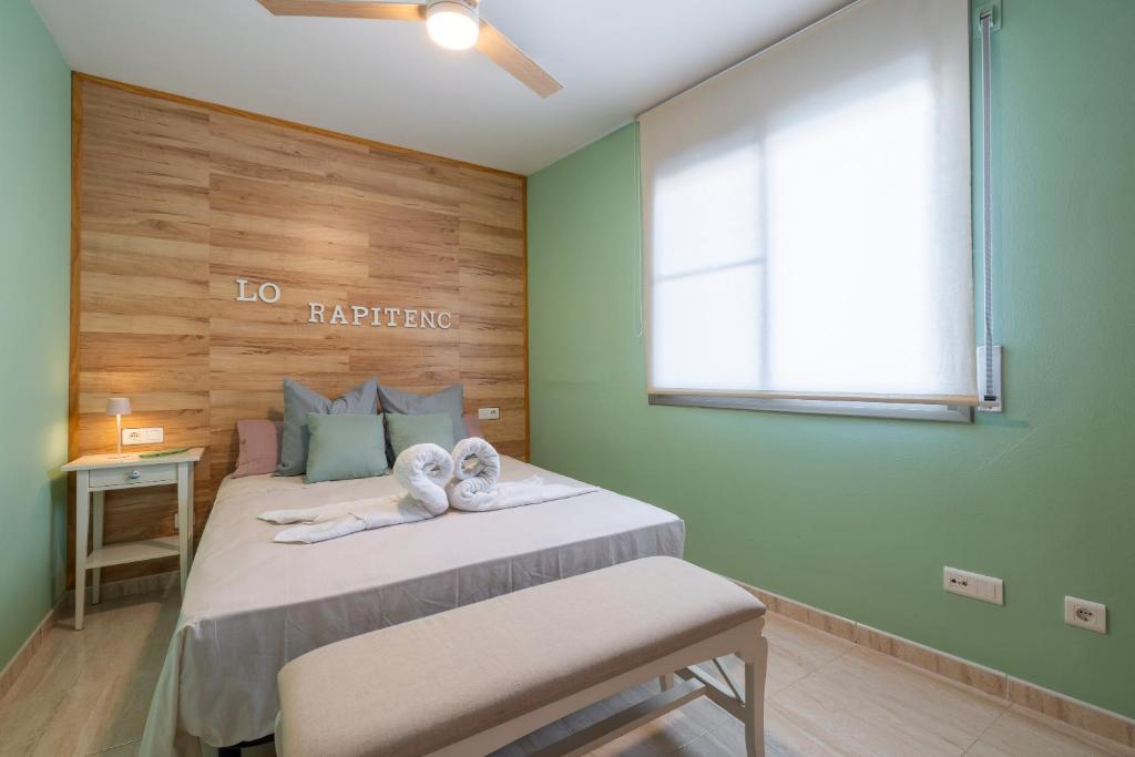 a bedroom with a large bed with a window at Rapitenc in Sant Carles de la Ràpita