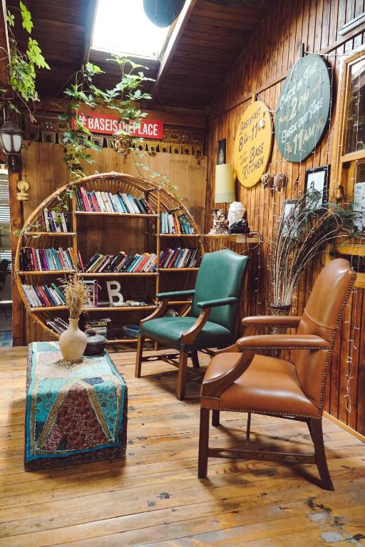 a room with several chairs and books on a wall at Base Bungalows in Olympos