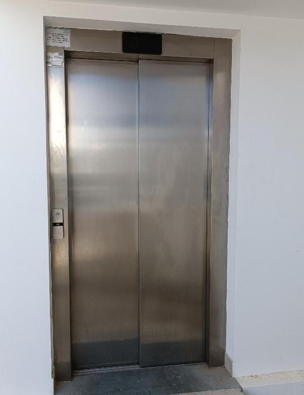 a large metal elevator door in a building at Georgia Hotel Apartments in Protaras