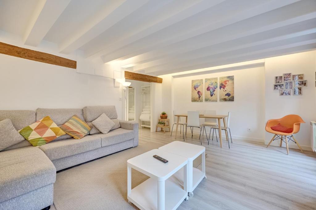 a living room with a couch and a table at El Mirador de la Estafeta by Clabao in Pamplona