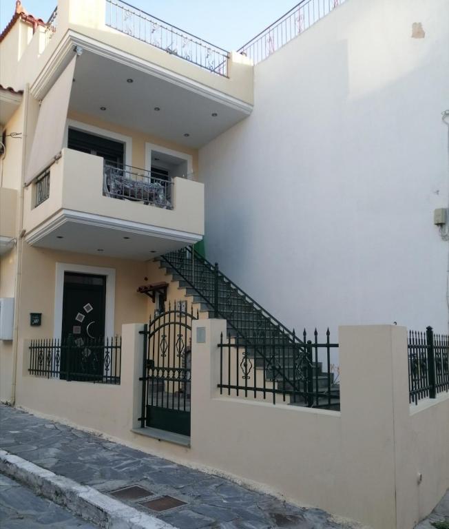 a white building with stairs on the side of it at Aellia-Beautiful apartment in Vathi Samos in Vathý