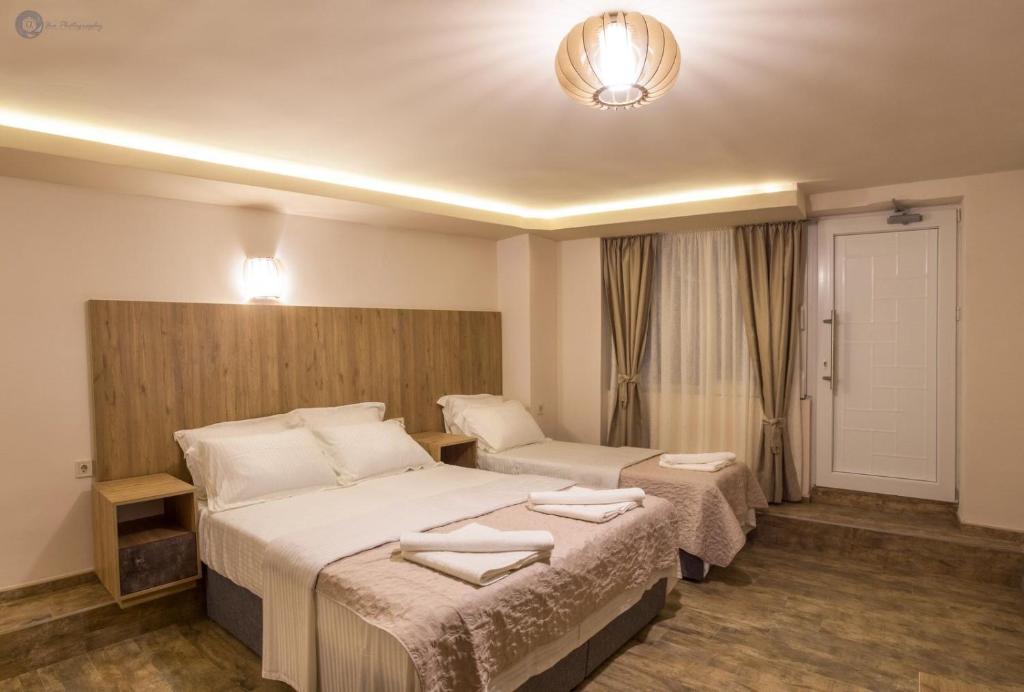 a hotel room with two beds and a door at Villa Montemaris Budva in Budva