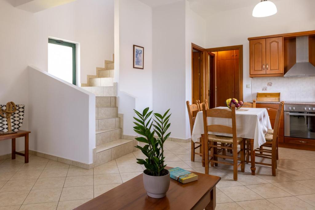 a kitchen and a dining room with a table and a kitchen at Villas Almyrida in Almyrida