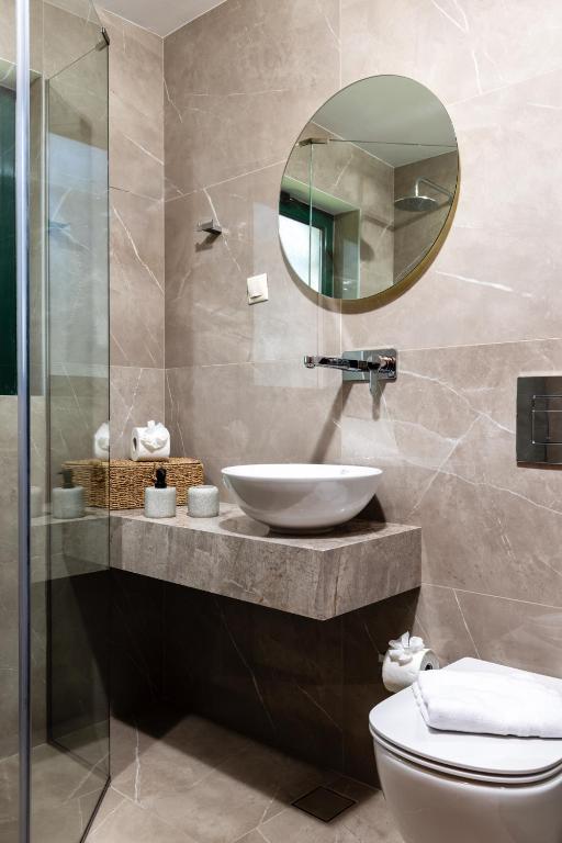 a bathroom with a sink and a mirror at Villas Almyrida in Almyrida