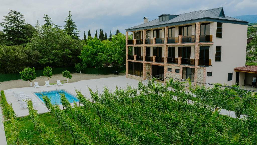 a large house with a swimming pool in front of it at Villa Ikalto in Telavi