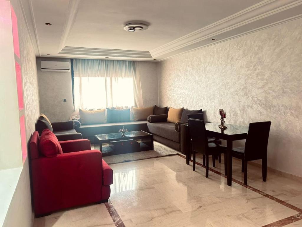 a living room with a couch and a table at appartement a hassan rabat in Rabat