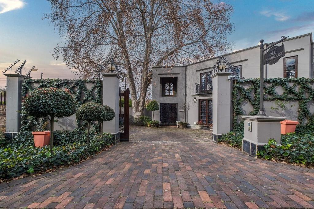 a large white building with a brick driveway at Ataraxia Place in Krugersdorp