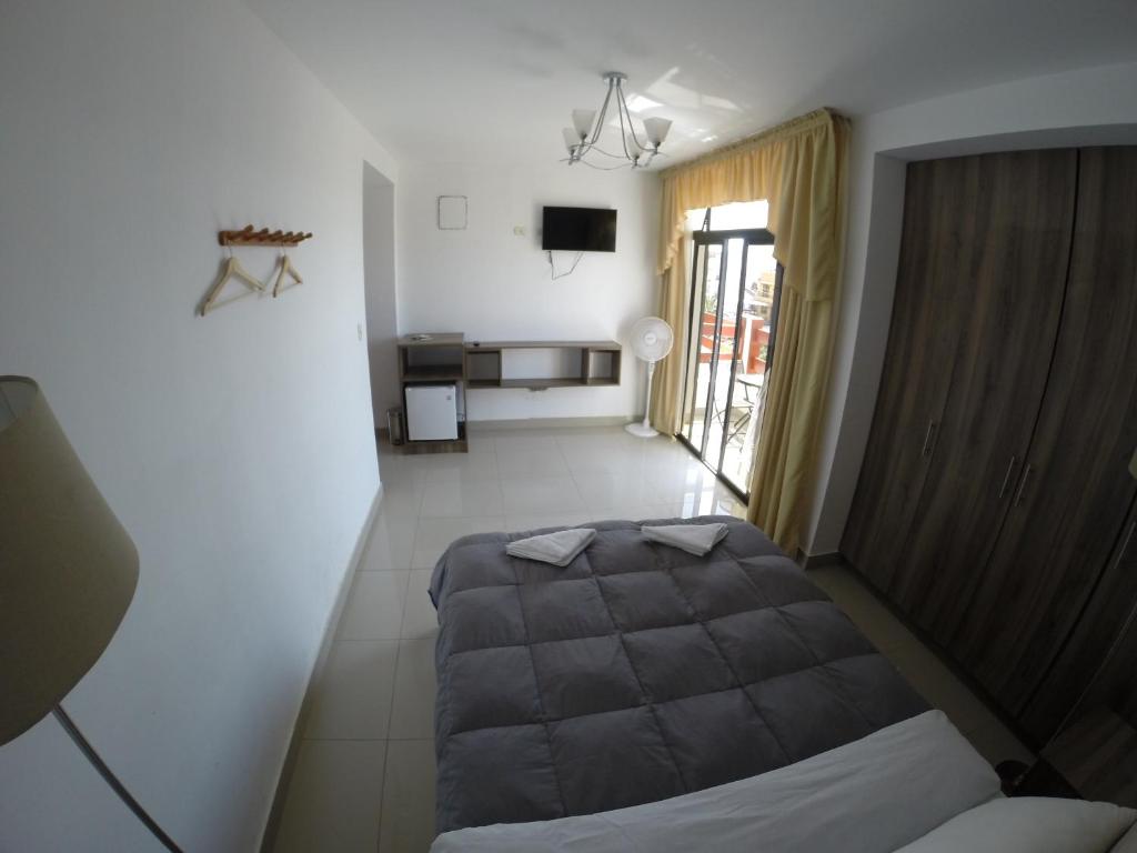 Tempat tidur dalam kamar di Hotel Residencial Los Frayles