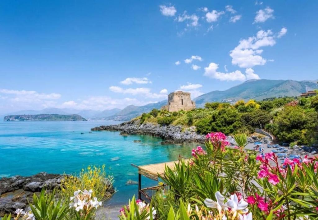 a view of a lake with a castle in the distance at Scalea Olive and Wine in Scalea