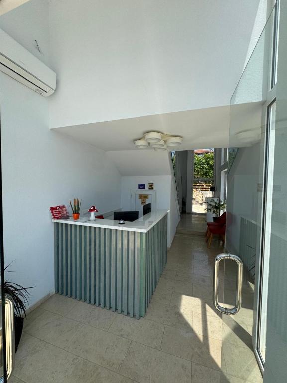 a kitchen with a green and white counter in a room at Otto Hotel in Ksamil