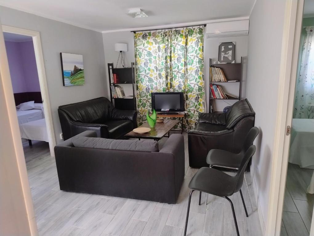 a living room with a couch and a table and chairs at Alojamiento a 25km de Madrid apta para mascotas cerca de zonas de ocio in Navalcarnero