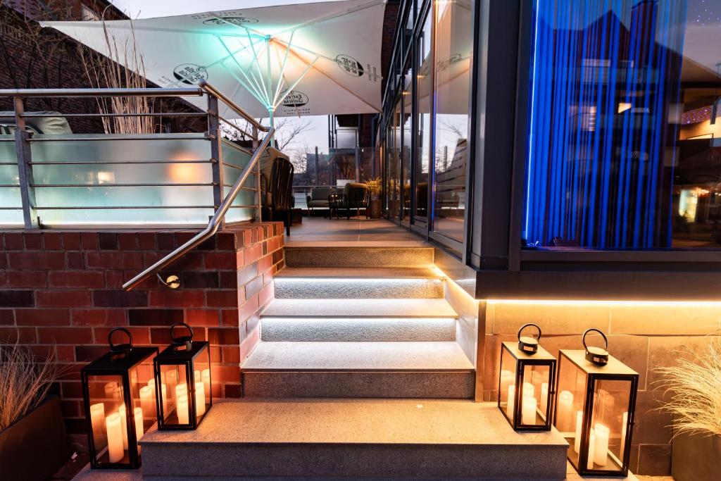 a set of stairs with lights on the side of a building at Hotel Atlantic Juist in Juist