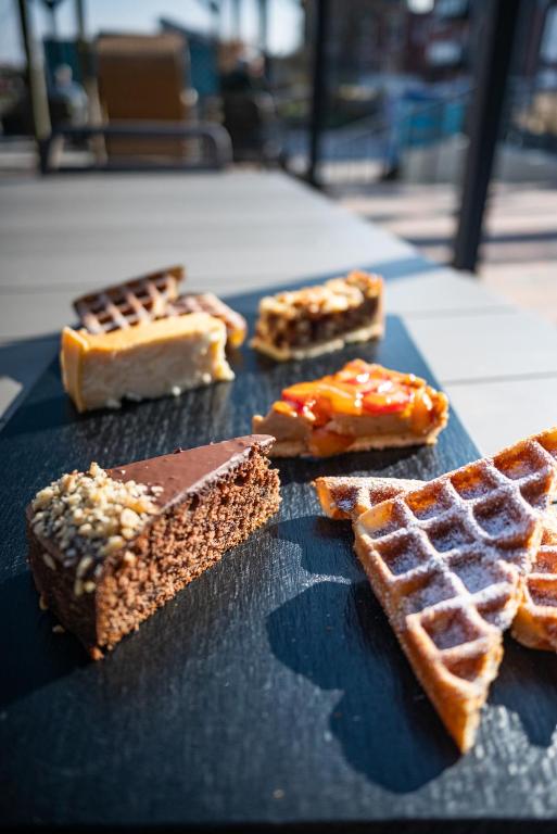 a table topped with waffles and waffle at Hotel Atlantic Juist in Juist