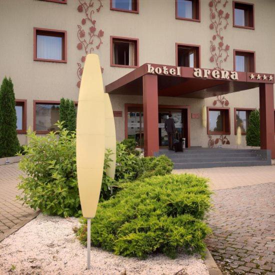 a surfboard is standing in front of a hotel at Hotel Arena in Târgu-Mureş
