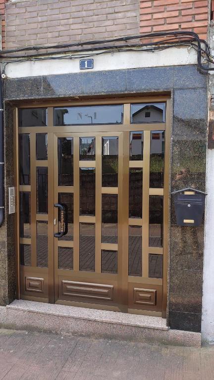 a double door of a building with a phone at casa 1, 2 o 3 habitaciones - HOSTAL CAMELOT in Fabero