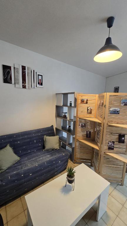 a living room with a couch and a table at Perle des Bords de Loire in Blois