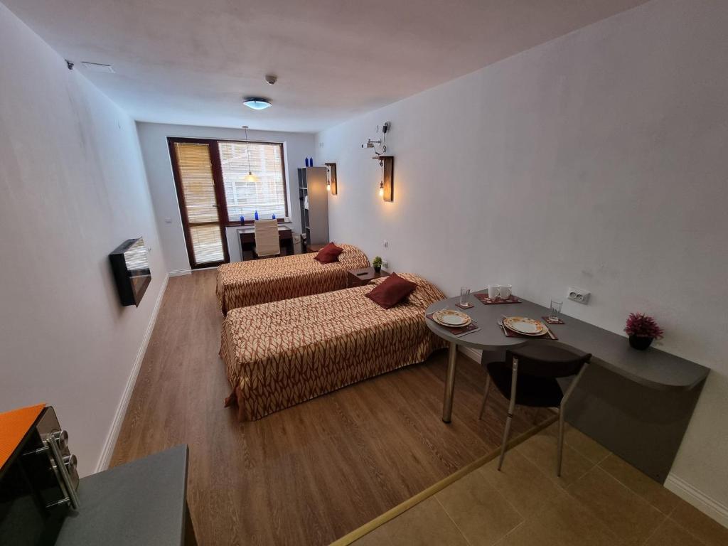 a living room with a couch and a table at Mountain Paradise 2 - Quiet Cosy Studio - Balcony, Wifi in Bansko