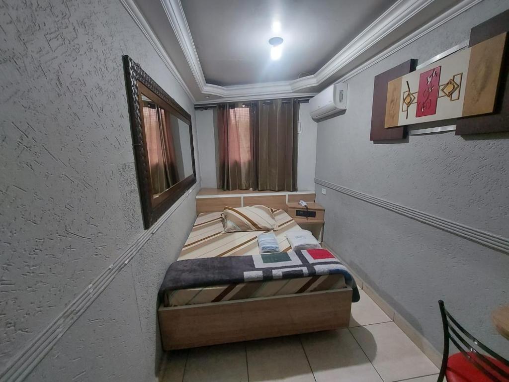 a small bedroom with a bed in a room at Hotel Luar in Sao Paulo
