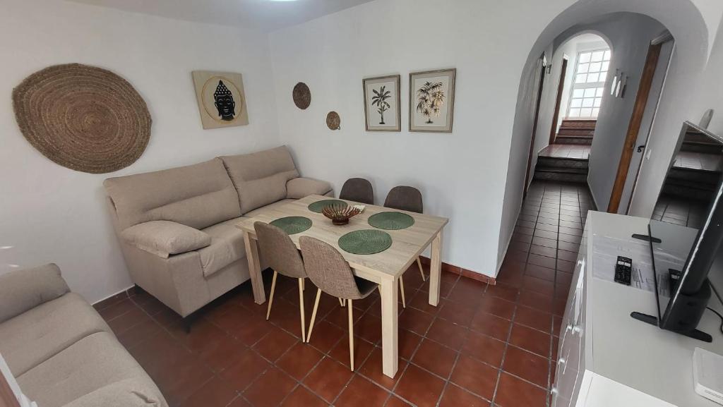 a living room with a table and a couch at Buenavista in Ayamonte