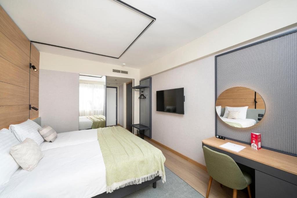 Postel nebo postele na pokoji v ubytování Hotel Pelegrin Plava Laguna