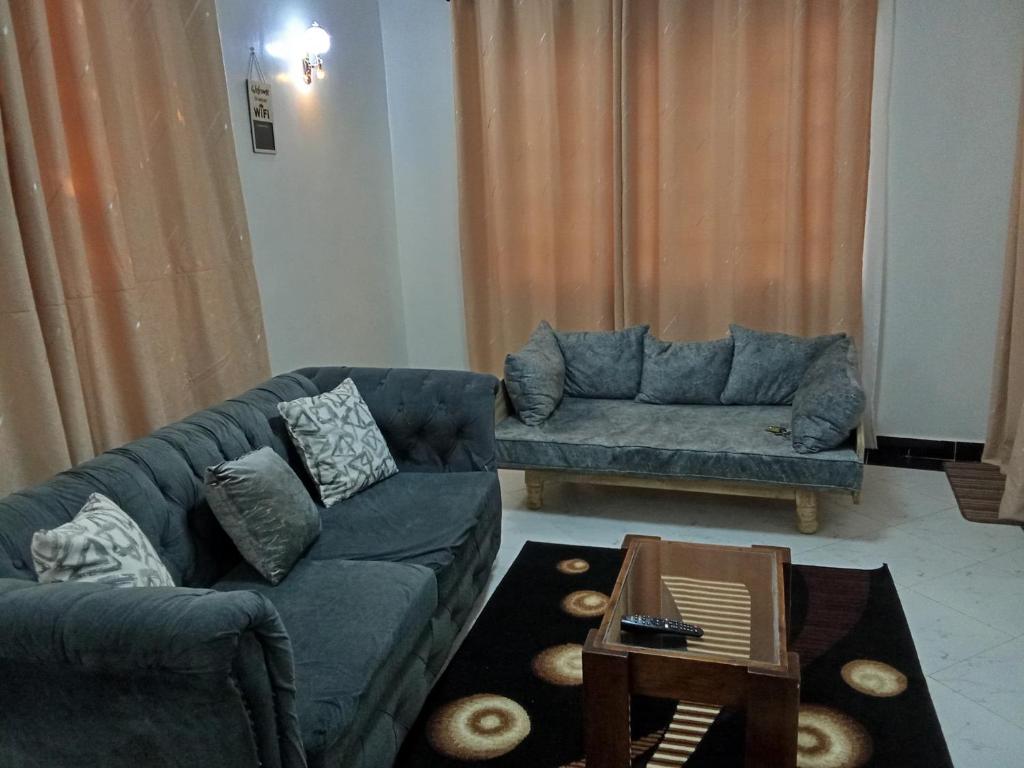 a living room with two couches and a coffee table at Leilani Homes in Kajiado