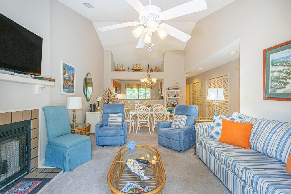 a living room with a couch and chairs and a tv at Spacious 2 Bedroom Condo- Vaulted Ceilings and Fireplace- St James Park 12-E in Myrtle Beach