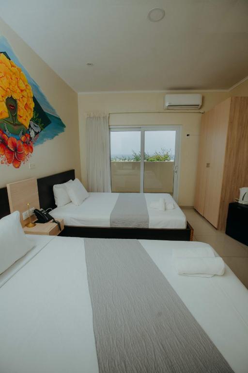 Postel nebo postele na pokoji v ubytování Curacao Airport Hotel