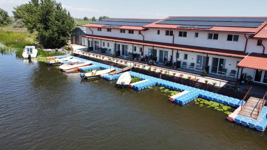 an aerial view of a resort on the water at Pensiunea La Miluta in Caraorman