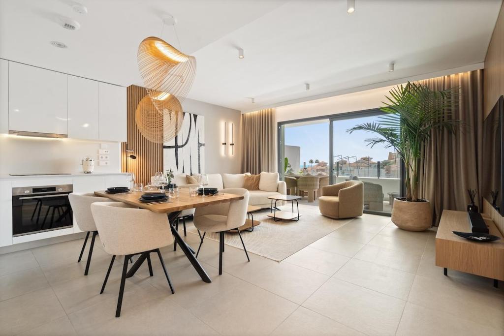 ミハス・コスタにあるStylish 2-Bed Retreat in Ipanema Homes - RDR500のテーブルと椅子のあるキッチンとリビングルーム