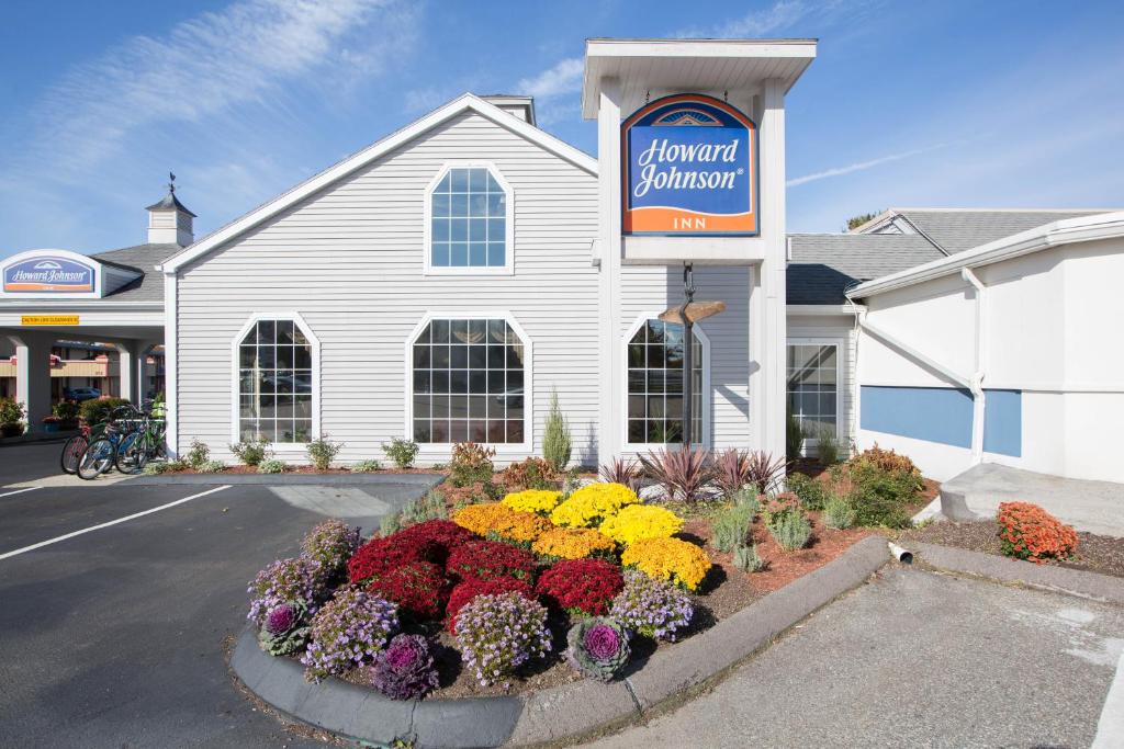 a church with a bunch of flowers in front of it at Howard Johnson by Wyndham Mystic in Mystic