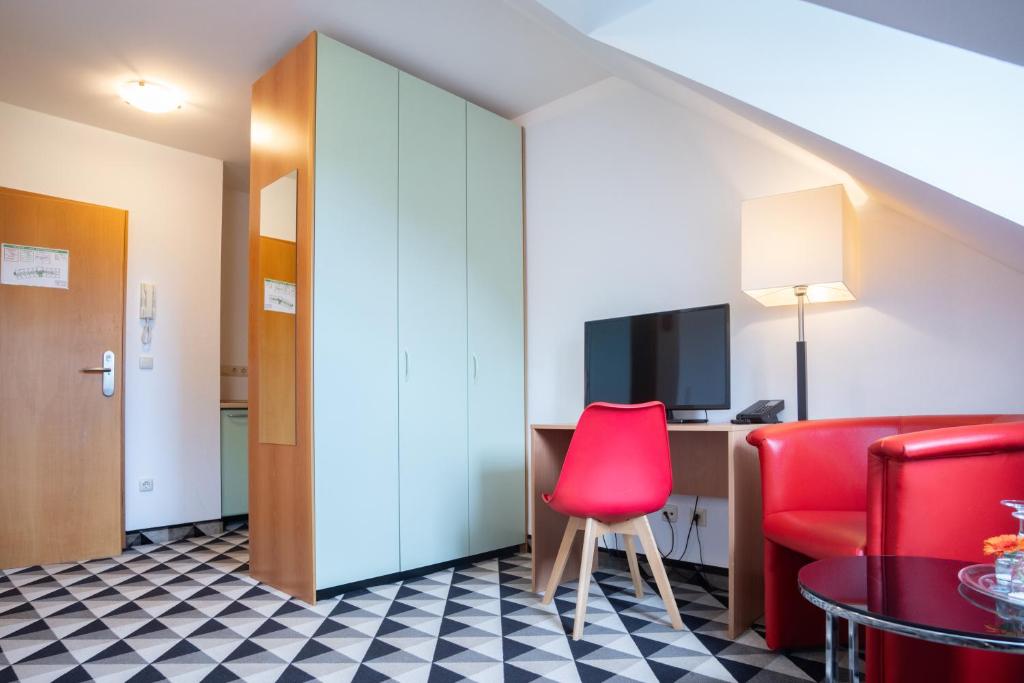 TV a/nebo společenská místnost v ubytování Andante Hotel Erding
