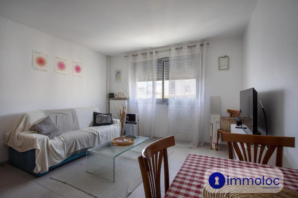 un salon avec un canapé et une table dans l'établissement Studio near airport, à Nice