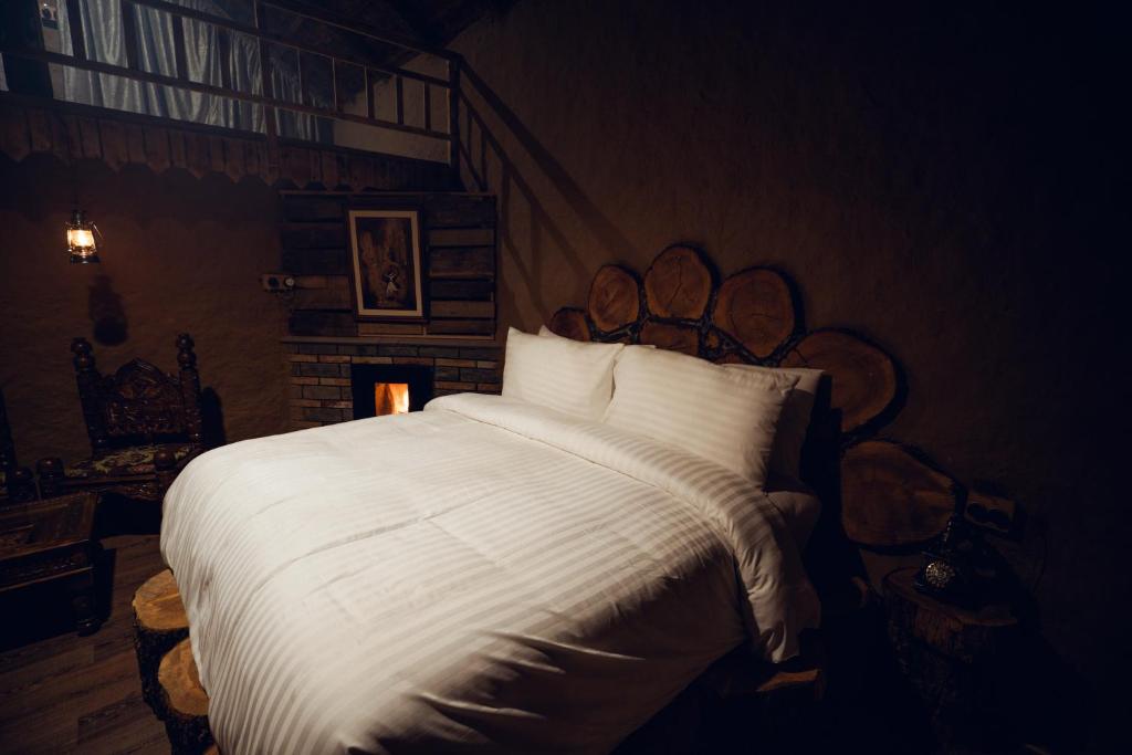 a bedroom with a large bed with white sheets at Azure Lagoon Resort 