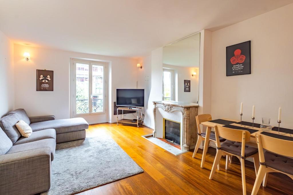 - un salon avec un canapé, une table et une cheminée dans l'établissement 6 Guests Flat - Jardin des Plantes, à Paris