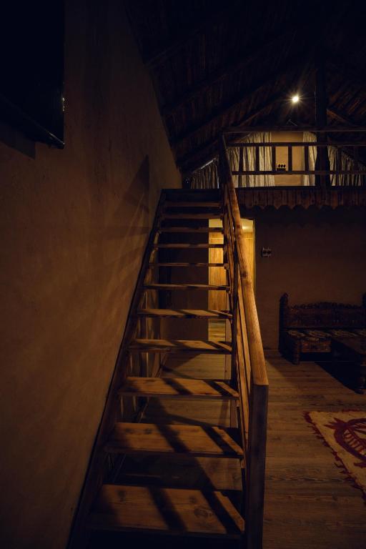 a wooden staircase in a room with a light at Azure Lagoon Resort 