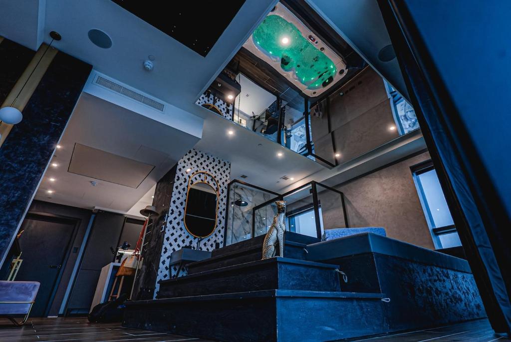 a room with a staircase and a green light at 2401 at Mercury by AURA in St. Julianʼs