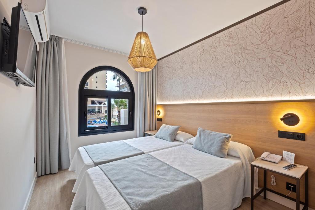 Postel nebo postele na pokoji v ubytování Hotel Puente Real