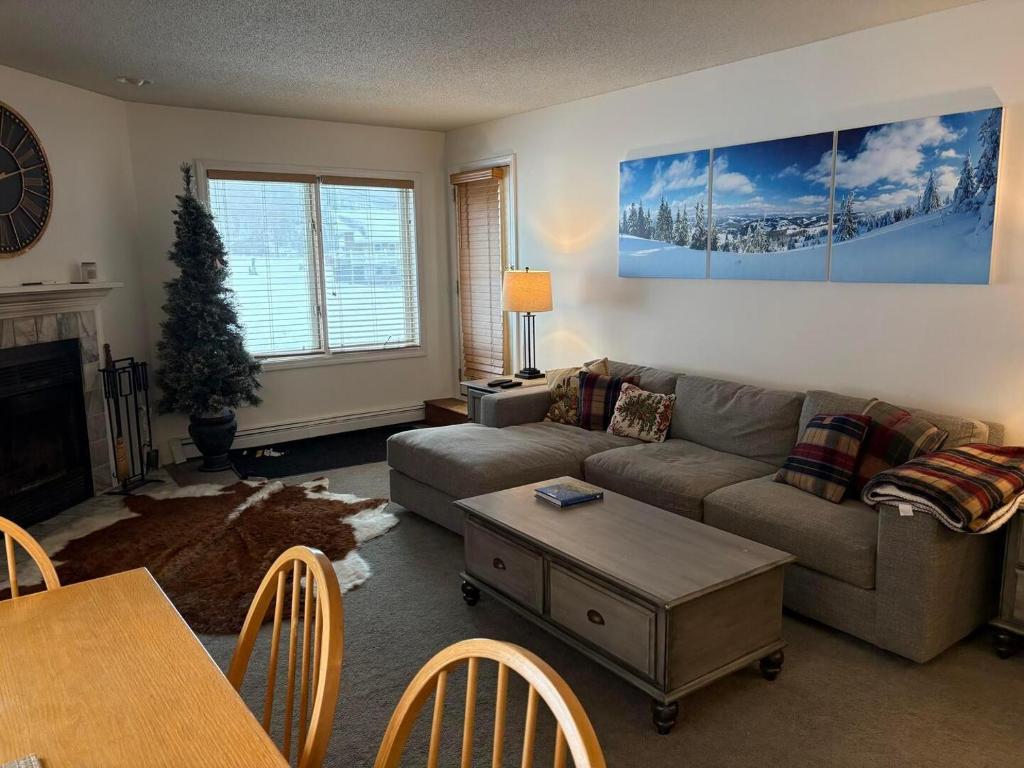 a living room with a couch and a table at Pico F101 in Killington