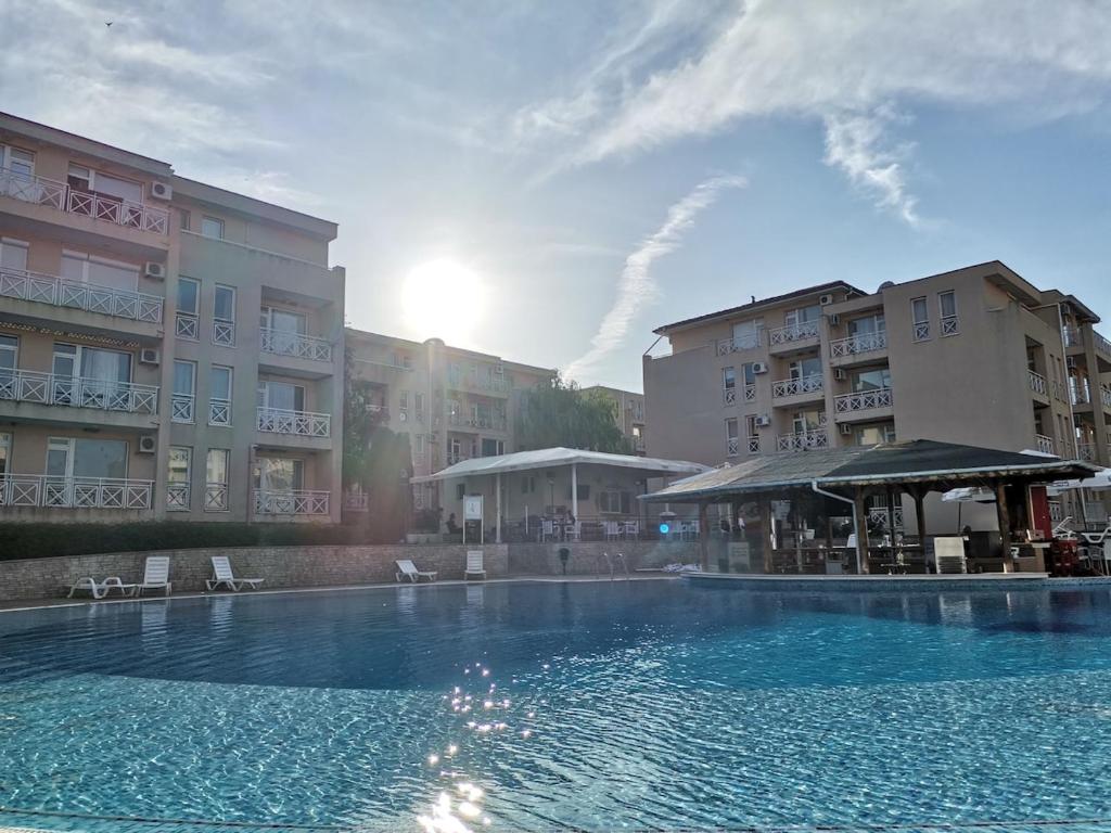 a large swimming pool in front of some buildings at Family Studio flat in Tŭnkovo