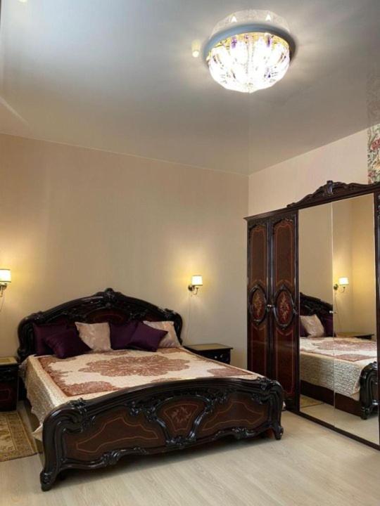a bedroom with a bed and a large mirror at Zacahry Apartments in Helsinki