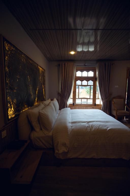 a bedroom with a large bed and a window at Azure Lagoon Resort 