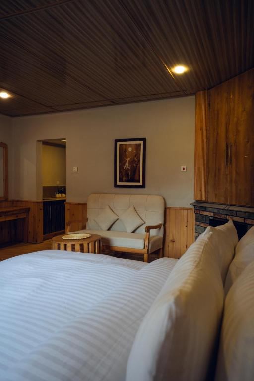 a bedroom with a large bed and a couch at Azure Lagoon Resort 