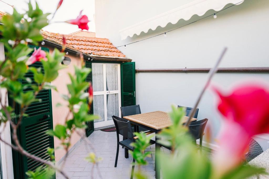 a patio with a table and chairs and a building at Terrazza d'Amare - Alassio Centro in Alassio