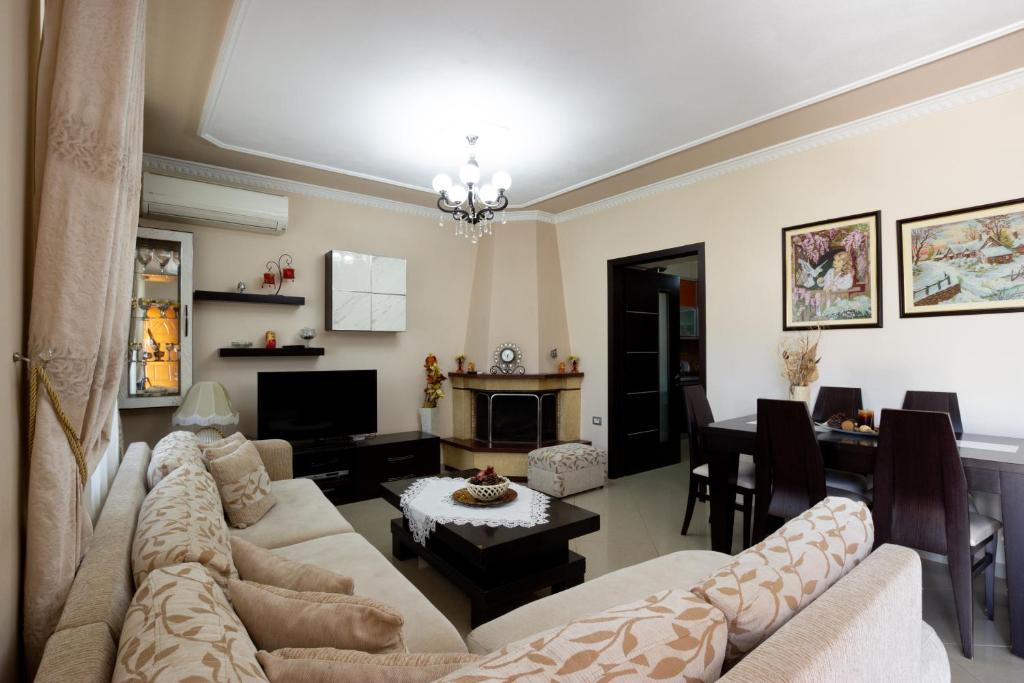 a living room with a couch and a table at Doel's Villa in Gjirokastër