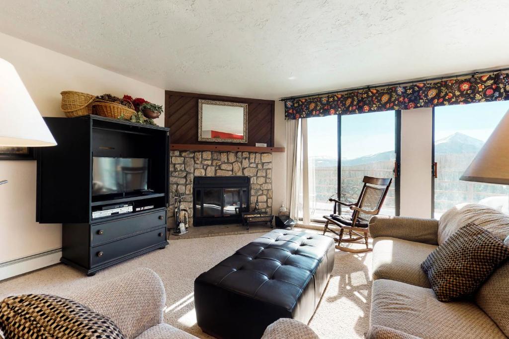 a living room with a television and a fireplace at Buffalo Ridge 205 in Silverthorne