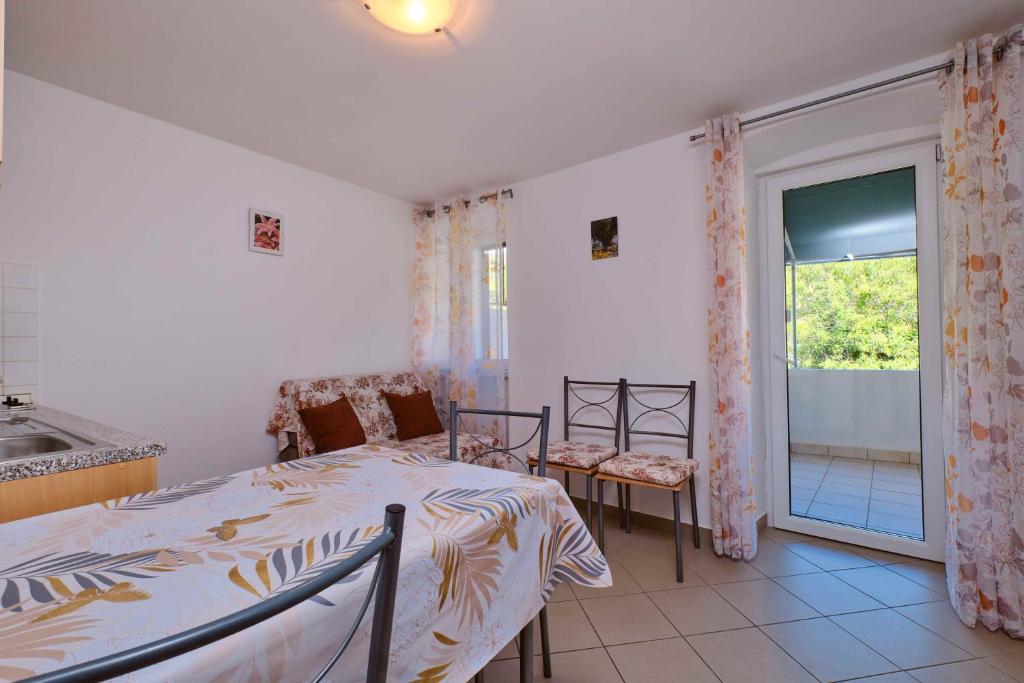 a bedroom with a bed and a sink and a window at Mario in Martinšćica