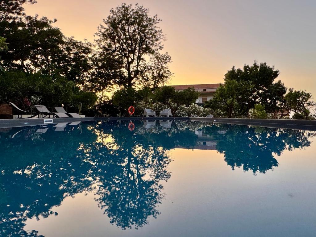 a swimming pool with a stop sign and trees at Stunning Property with Private Pool in Cefalù in Cefalù