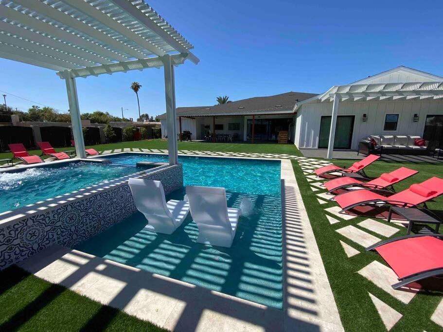 a swimming pool with lounge chairs and a swimming pool at The Phoenix Farmhouse in Phoenix