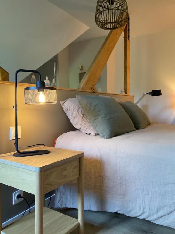 une chambre avec un lit et une table avec une lampe dans l'établissement Ty ar gwez, à Plogonnec
